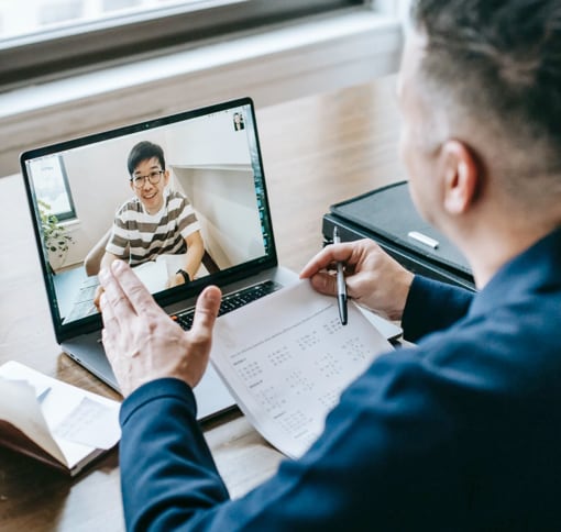 Image of a man in a video call on laptop with another man