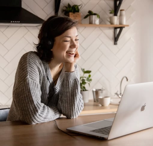 Image of a woman looking at her latop screen