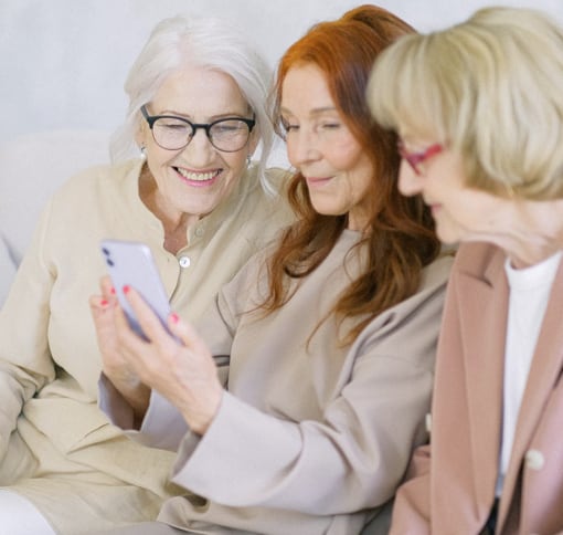 Image of 3 women looking at mobile phone screen